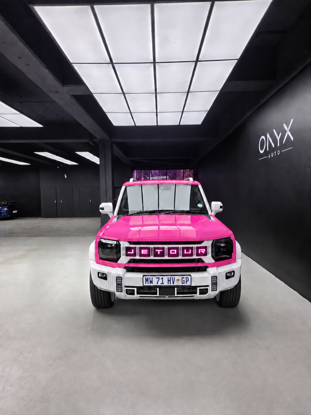 Front view with illuminated pink JETOUR grille lettering