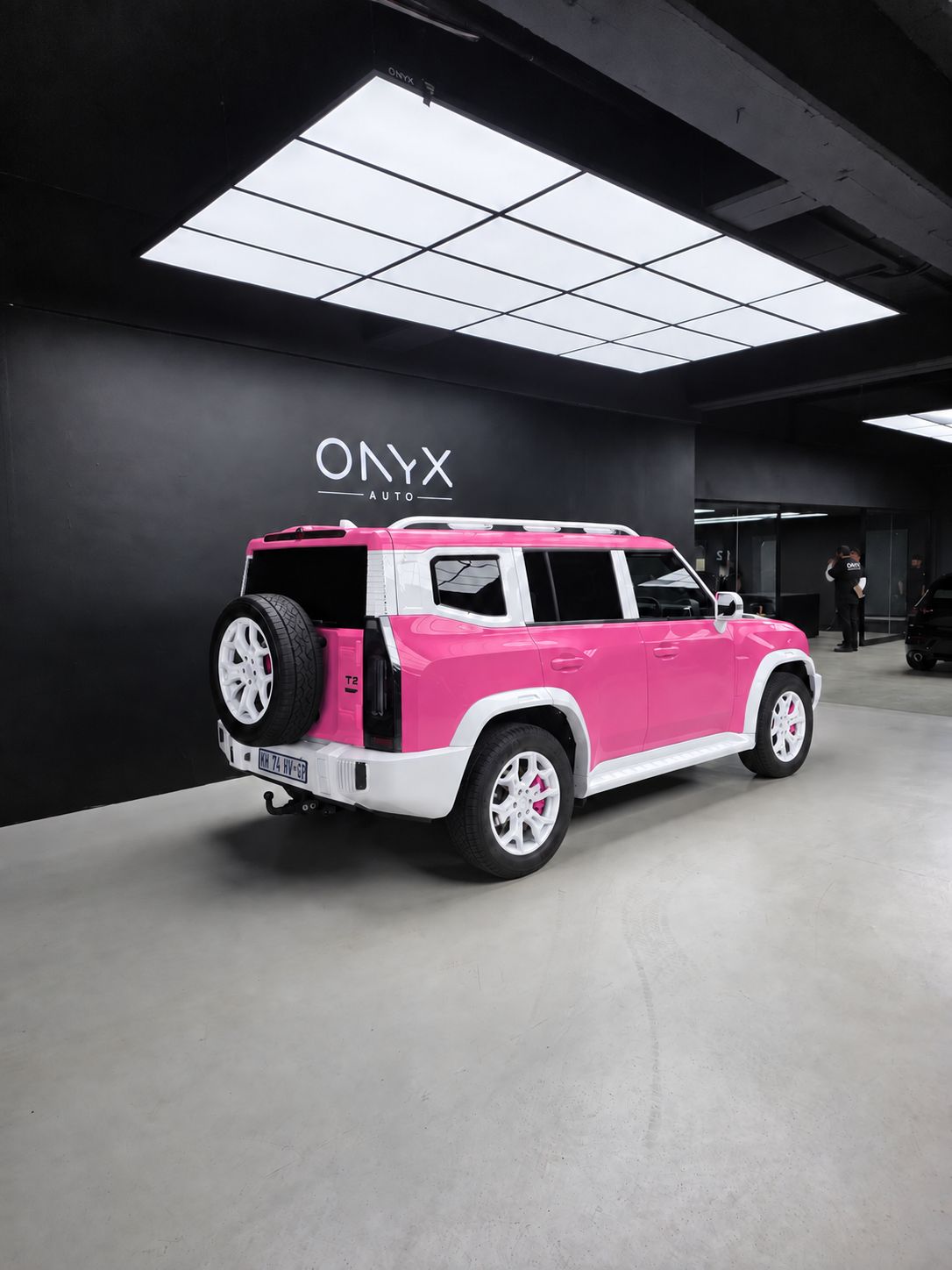 Pink and white Jetour T2 rear three-quarter view